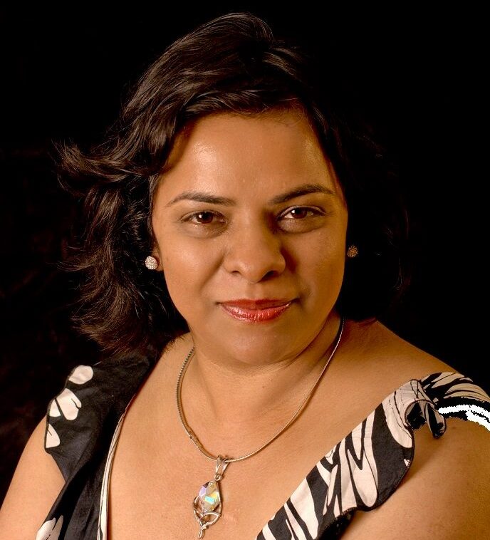 Woman smiling with short dark hair.